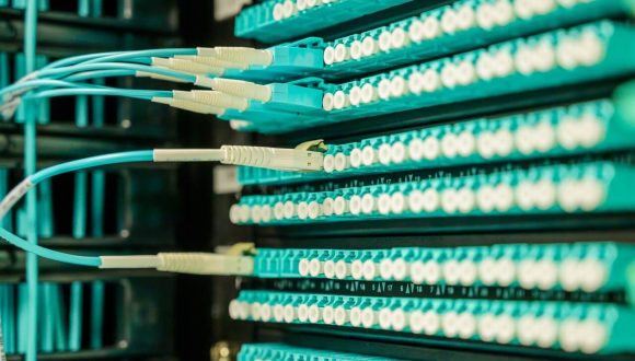 Wires plugged into the back of servers