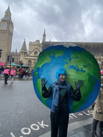 Woman dressed up as planet Earth at the Big One protest
