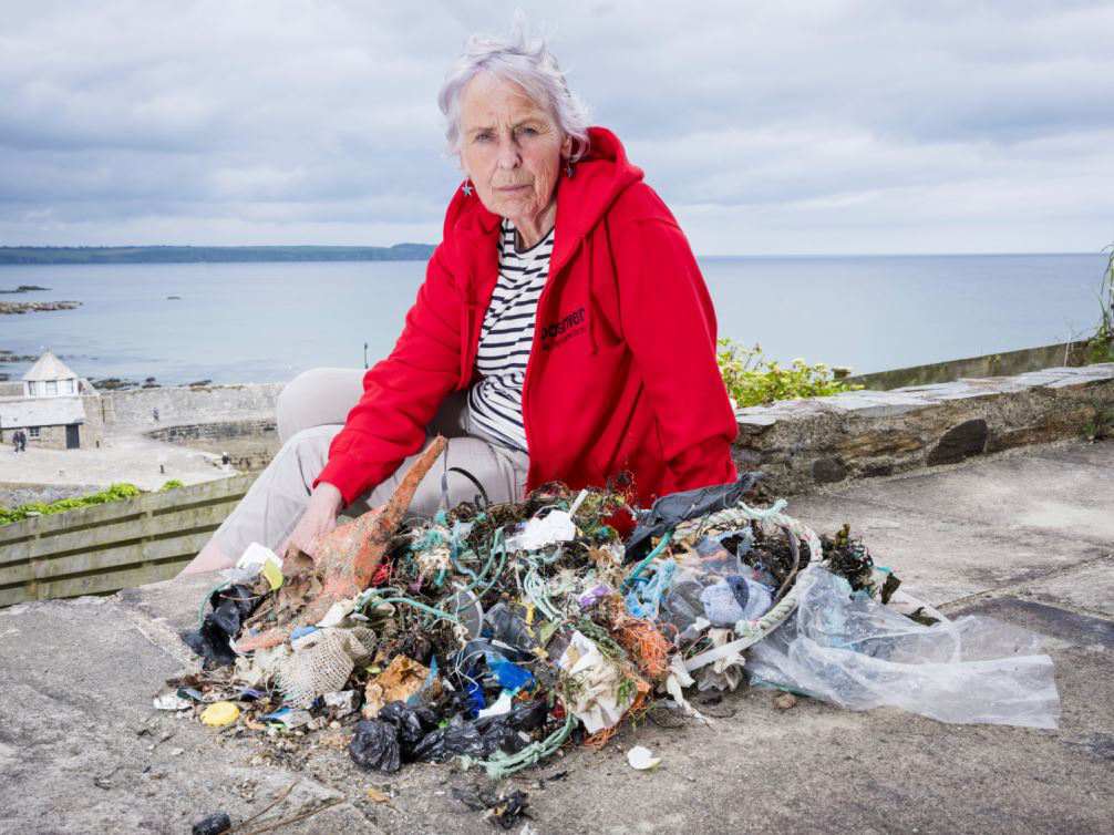 Action Nan fighting both ageism and plastic pollution. Pictured on the beach with her collected plastic litter